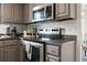 Close up view of stainless steel stove and microwave in gray kitchen at 1108 Blue Juniper Ct., Conway, SC 29527