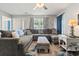 Comfortable living room featuring a large sectional sofa, ceiling fan, and natural light at 1108 Blue Juniper Ct., Conway, SC 29527