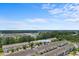 Aerial view of the townhome community at 1123 Fairway Lane with trees and blue sky at 1123 Fairway Ln. # 1123, Conway, SC 29526