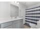 Clean bathroom featuring a vanity, toilet, and striped shower curtain at 1123 Fairway Ln. # 1123, Conway, SC 29526