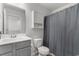 Well-lit bathroom with vanity, toilet, and tub with shower curtain for privacy at 1123 Fairway Ln. # 1123, Conway, SC 29526