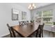 Cozy dining area features a wooden table with six chairs and a modern chandelier over the space at 1123 Fairway Ln. # 1123, Conway, SC 29526