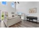 Bright living room with high ceilings, large sofa, piano, and decorative shelving at 1123 Fairway Ln. # 1123, Conway, SC 29526