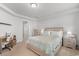 Bright main bedroom features neutral tones, a queen bed and an ensuite bathroom at 1123 Fairway Ln. # 1123, Conway, SC 29526
