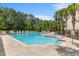 Community swimming pool with plenty of lounge chairs and palm trees, offering a resort lifestyle at 1123 Fairway Ln. # 1123, Conway, SC 29526