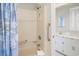 Bathroom with a shower and bathtub, safety bars, and vanity with white cabinets, and marble top at 1184 Parker Dr., Pawleys Island, SC 29585
