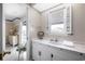Well-lit bathroom with white vanity, marble countertop, a window with shutters, and light wood floors at 1184 Parker Dr., Pawleys Island, SC 29585