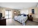 Comfortable bedroom with a queen bed, blue accents, and access to a private balcony at 1184 Parker Dr., Pawleys Island, SC 29585