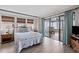 Cozy bedroom featuring a queen bed and sliding doors to a covered porch with ocean views at 1184 Parker Dr., Pawleys Island, SC 29585