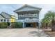 Charming coastal home featuring multi-level balconies and covered parking at 1184 Parker Dr., Pawleys Island, SC 29585