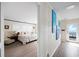 Hallway view leading into a well-appointed bedroom with beach views, complemented by coastal-themed artwork at 1184 Parker Dr., Pawleys Island, SC 29585