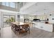 Bright open kitchen with large island, breakfast bar, light wood floors, and a spacious dining area at 1184 Parker Dr., Pawleys Island, SC 29585