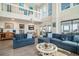 Bright living room boasts soaring ceilings, balcony, and comfortable seating at 1184 Parker Dr., Pawleys Island, SC 29585