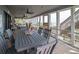 Covered porch has a large dining table, ceiling fans, and beach view at 1184 Parker Dr., Pawleys Island, SC 29585