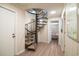 Interior view of a carpeted spiral staircase with access to a bedroom with twin beds at 1184 Parker Dr., Pawleys Island, SC 29585