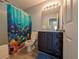 Colorful bathroom with a tub and shower combination featuring a themed shower curtain and updated vanity at 119 Brentwood Dr. # D, Murrells Inlet, SC 29576