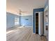 This bedroom features a calming blue palette, light-wood floors, and a modern ceiling fan for comfort at 119 Brentwood Dr. # D, Murrells Inlet, SC 29576