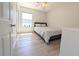 Comfortable bedroom featuring a bed, wood-look floors, and a window for natural light at 119 Brentwood Dr. # D, Murrells Inlet, SC 29576
