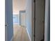 The hallway features soothing blue walls, a light-wood floor, and white doors for a serene touch at 119 Brentwood Dr. # D, Murrells Inlet, SC 29576