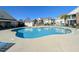 Community pool with a spacious concrete deck, lounge chairs, and seating area, offering a great place to relax and enjoy at 119 Brentwood Dr. # D, Murrells Inlet, SC 29576