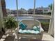 The screen porch offers comfy wicker seating with a tranquil pond and community views at 119 Brentwood Dr. # D, Murrells Inlet, SC 29576