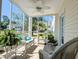 Enjoy the spacious screened porch with inviting white wicker furniture, plants, and views of the landscaped yard at 119 Brentwood Dr. # D, Murrells Inlet, SC 29576