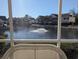 Scenic water view from the screened porch overlooking a pond with a fountain and multiple residential buildings beyond at 119 Brentwood Dr. # D, Murrells Inlet, SC 29576