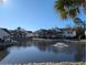 Beautiful water view overlooking a pond with a fountain, with multiple residential buildings visible beyond it at 119 Brentwood Dr. # D, Murrells Inlet, SC 29576
