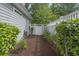 View of the side yard featuring a white vinyl fence and a mulched garden area at 119 Pickerel Blvd., Longs, SC 29568