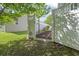 Lawn and trees as seen through an opening in a white vinyl fence with green tree overhead at 119 Pickerel Blvd., Longs, SC 29568