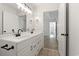 Bathroom featuring a double vanity with black hardware and a view to an adjacent hall at 119 Pickerel Blvd., Longs, SC 29568