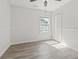 Bedroom with large window allowing for ample natural light and laminate flooring at 119 Pickerel Blvd., Longs, SC 29568
