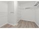 Walk-in closet with installed shelving and laminate flooring at 119 Pickerel Blvd., Longs, SC 29568