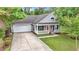 Charming one-story home with a front porch, well-manicured lawn, and a driveway at 119 Pickerel Blvd., Longs, SC 29568