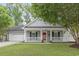 Charming single-story home featuring a welcoming front porch, well-manicured lawn, and an attached garage at 119 Pickerel Blvd., Longs, SC 29568