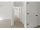 Hallway featuring light gray wood-look flooring and bright white walls and doors at 119 Pickerel Blvd., Longs, SC 29568