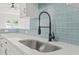Close-up of the kitchen sink, highlighting its modern faucet and stylish subway tile backsplash at 119 Pickerel Blvd., Longs, SC 29568