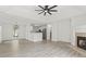 Open-concept living room with a fireplace, modern flooring, and a view into the kitchen at 119 Pickerel Blvd., Longs, SC 29568