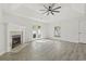 Bright living room featuring a fireplace, white trim, neutral walls, luxury vinyl plank flooring and door to patio at 119 Pickerel Blvd., Longs, SC 29568