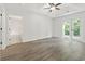 Well-lit bedroom with French doors to the backyard patio and an en-suite bathroom at 119 Pickerel Blvd., Longs, SC 29568