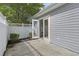 Outdoor patio area featuring white vinyl fencing and gray siding and a sliding glass door at 119 Pickerel Blvd., Longs, SC 29568