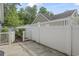 Exterior view of the private, fenced-in patio area with concrete floor and white vinyl fence at 119 Pickerel Blvd., Longs, SC 29568