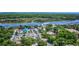 Expansive aerial shot of a waterfront community featuring lush green landscapes, a river, and ample parking at 120 Triston Ct., Little River, SC 29566