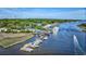 Beautiful aerial panorama of a coastal town featuring waterfront restaurants, marinas, and lush green landscapes at 120 Triston Ct., Little River, SC 29566