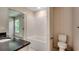 Bathroom featuring granite countertop, white cabinets, and a bathtub at 120 Triston Ct., Little River, SC 29566