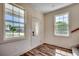 Bright foyer featuring wood-look flooring, a decorative front door, and ample natural light at 120 Triston Ct., Little River, SC 29566