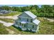 New construction home featuring vertical siding, a metal roof, and large windows for ample natural light at 120 Triston Ct., Little River, SC 29566