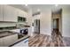 Modern kitchen features granite countertops, stainless steel appliances, and wood-look flooring at 120 Triston Ct., Little River, SC 29566