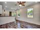 Open-concept living area boasts stylish flooring, ceiling fan, and lots of natural light at 120 Triston Ct., Little River, SC 29566