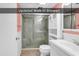 Updated bathroom featuring a walk-in shower with modern fixtures and a storage cabinet at 1210 N Waccamaw Dr. # 1008, Garden City Beach, SC 29576